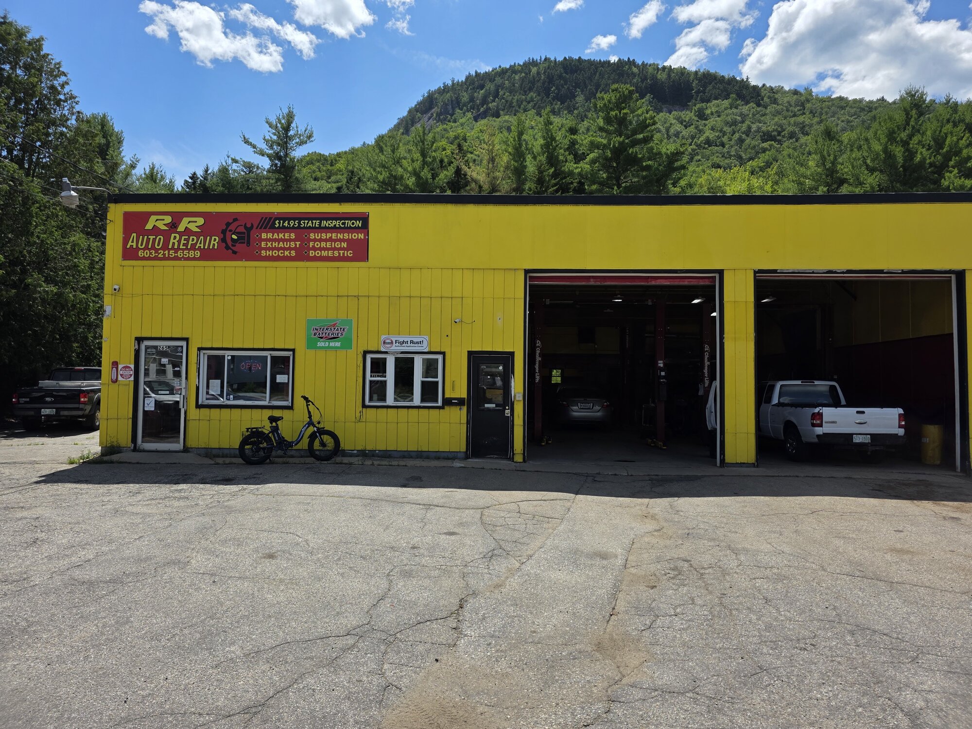 Roadside view of R&R Auto Repair on Wight Street, Berlin, NH with mountain backdrop